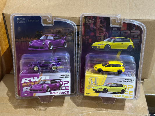 Two model car sets in packaging on a cardboard surface