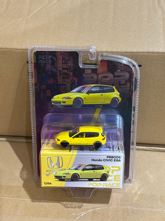 Yellow toy car in packaging on a beige background