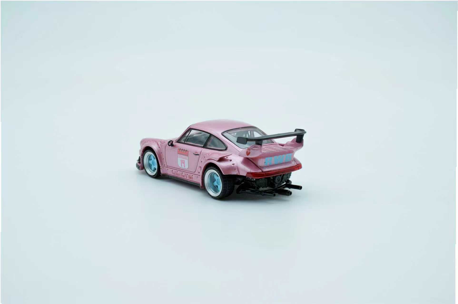 Pink toy car with black roof on a light gray background
