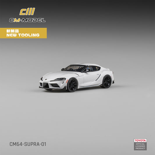 White toy car model of a Toyota Supra on a gray background with CM-Model branding.