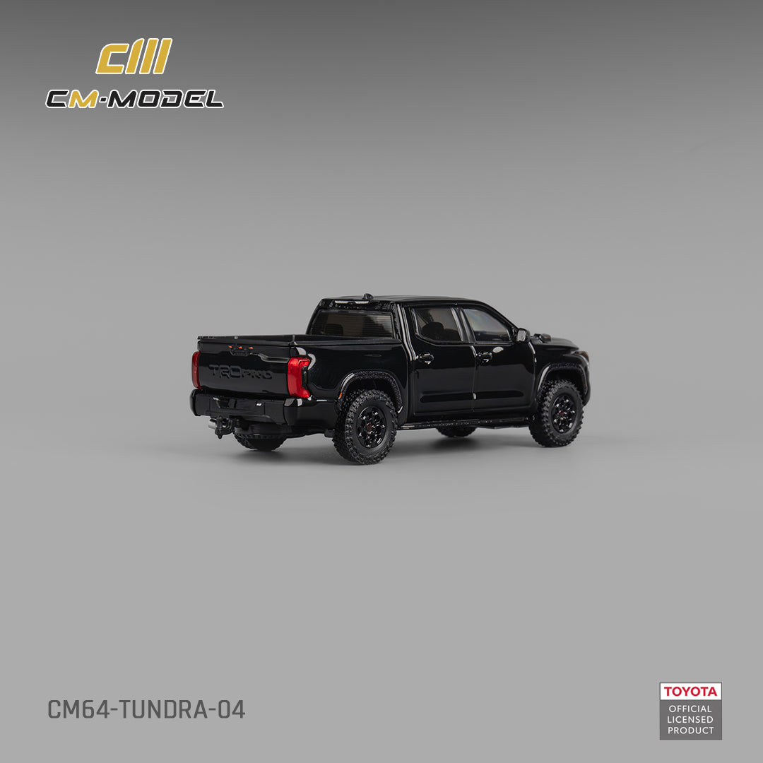 Black toy truck model on a gray background with CM-Model and Toyota logos.