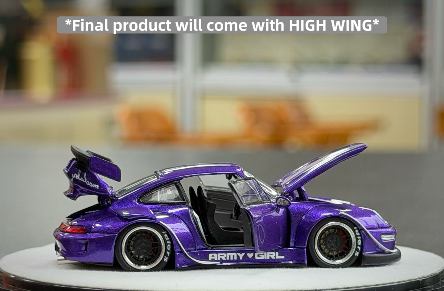 Purple model car with open doors on a round platform, text indicating 'Final product will come with HIGH WING'.