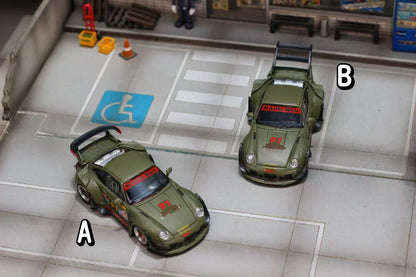 Two model cars on a platform with a disabled access sign in the background