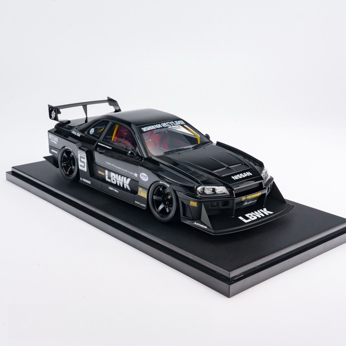 Black model car on a display stand with 'LBWK' branding