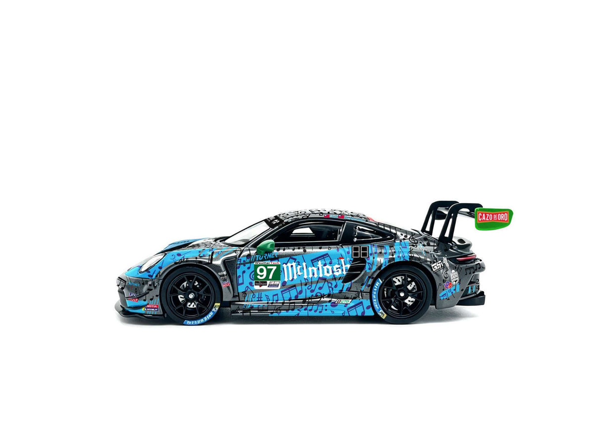 JICAR 1:64 911 GT3 R #97 Blue & Black Music Note Livery diecast model featuring musical note graphics, green side mirror, black racing wheels, large rear wing and detailed racing decals, side profile view