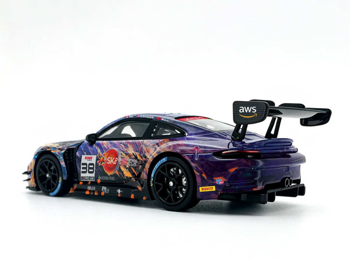 JICAR 1:64 GT3 Racing Car #32 The Scream Art Livery diecast model featuring purple, blue and orange abstract graphics, black racing wheels, large rear wing, dual exhaust pipes and detailed rear diffuser, rear three-quarter view.
