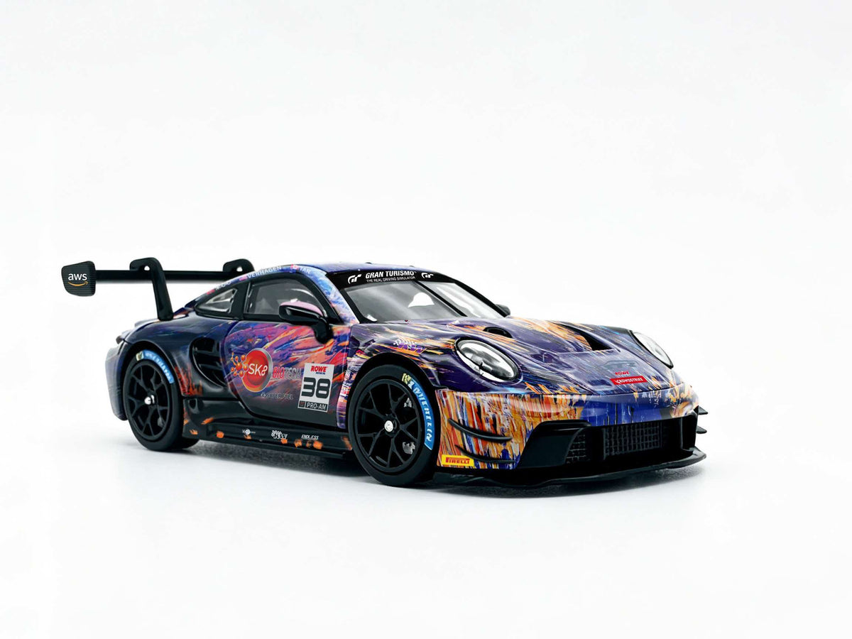 JICAR 1:64 GT3 Racing Car #32 The Scream Art Livery diecast model featuring purple, blue and orange abstract graphics, black racing wheels, detailed front splitter and large rear wing, front three-quarter view.