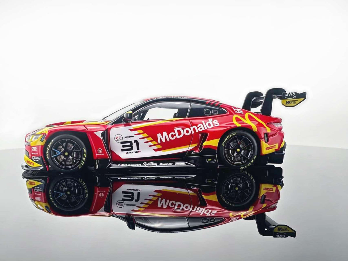 JICAR 1:64 M4 GT3 EVO #31 Red & Yellow Fast Food Racing Livery diecast model featuring red and yellow graphics, black racing wheels, detailed sponsor decals and large rear wing, side profile view.