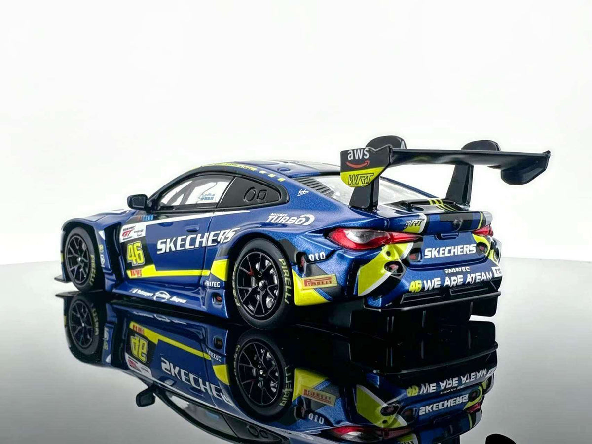JICAR 1:64 M4 GT3 EVO #46 Blue & Yellow Racing Livery diecast model featuring blue and yellow racing graphics, black racing wheels, detailed taillights, large rear wing and rear diffuser, rear three-quarter view.