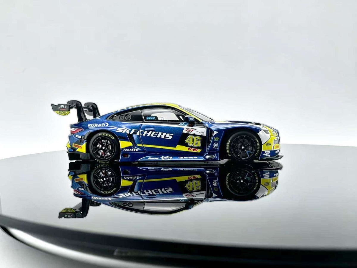 JICAR 1:64 M4 GT3 EVO #46 Blue & Yellow Racing Livery diecast model featuring blue and yellow racing graphics, black multi-spoke wheels, detailed sponsor decals, aerodynamic body kit and large rear wing, side profile view.