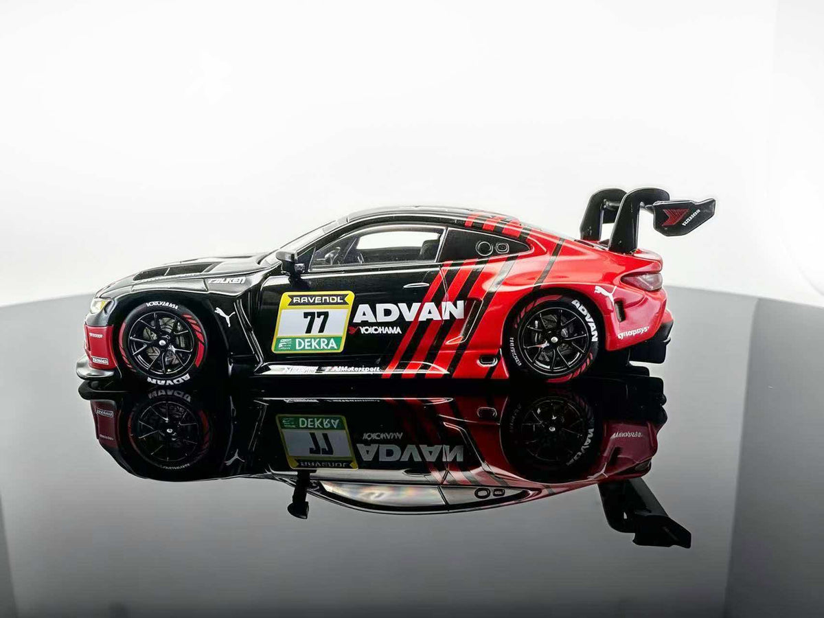 ICAR 1:64 M4 GT3 EVO #77 Black & Red Racing Livery diecast model featuring black and red ADVAN-style graphics, black multi-spoke racing wheels, detailed sponsor decals, aerodynamic body kit and large rear wing, side profile view.