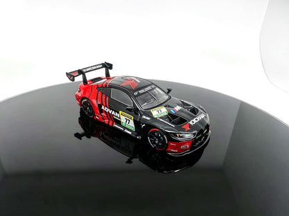 JICAR 1:64 M4 GT3 EVO #77 Black & Red Racing Livery diecast model featuring ADVAN-style graphics, black racing wheels, detailed hood vents, aerodynamic front splitter and large rear wing, elevated front three-quarter view.