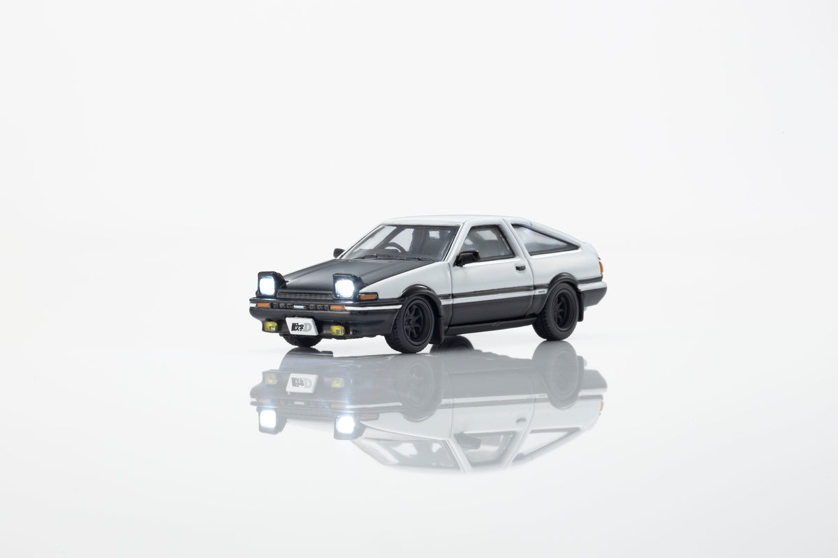 KYOSHO 1:64 Toyota Sprinter Trueno AE86 Initial D Fujiwara Tofu Shop white and black diecast model car with illuminated pop-up headlights