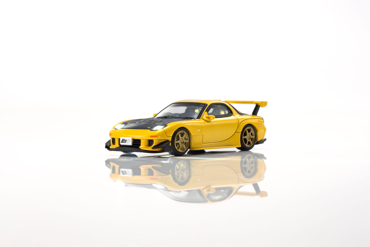 KYOSHO 1:64 Initial D Mazda RX-7 FD3S Keisuke Takahashi Yellow diecast model car with black carbon hood, rear wing and gold wheels