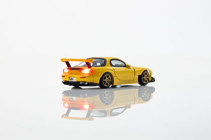 KYOSHO 1:64 Initial D Mazda RX-7 FD3S Keisuke Takahashi Yellow diecast model car with rear wing, gold wheels and illuminated taillights