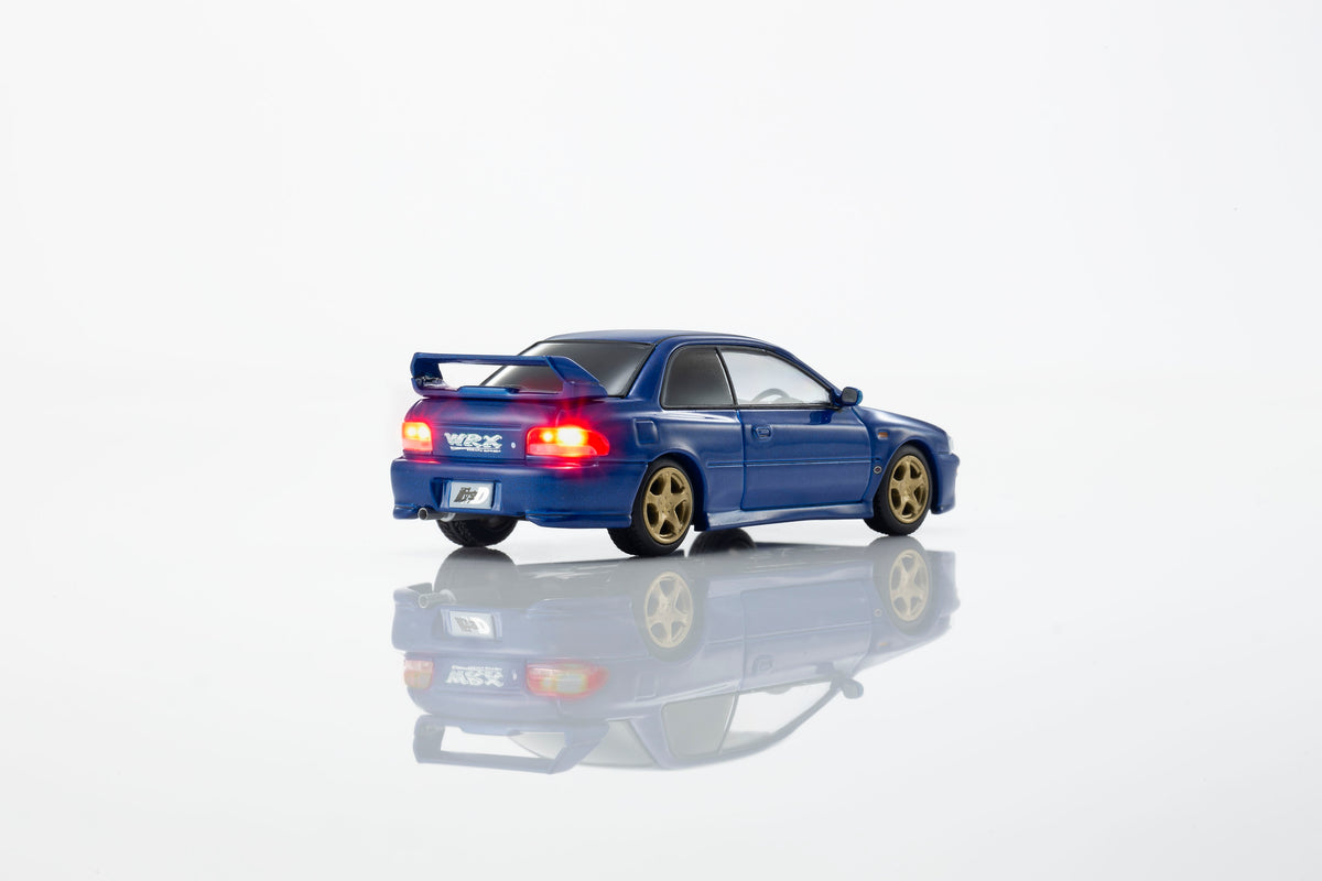 KYOSHO 1:64 Initial D Subaru Impreza WRX GC8 Bunta Fujiwara Blue diecast model car with gold wheels, rear wing and illuminated taillights