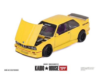 Yellow Kaido House BMW E3 M3 GT V12 scale model car with the hood open, displayed on a white background with product details and branding text below.