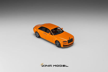 An orange diecast model car resembling a Rolls-Royce, shown from a three-quarters front angle on a gray gradient background with the 'KING MODEL' logo at the bottom.