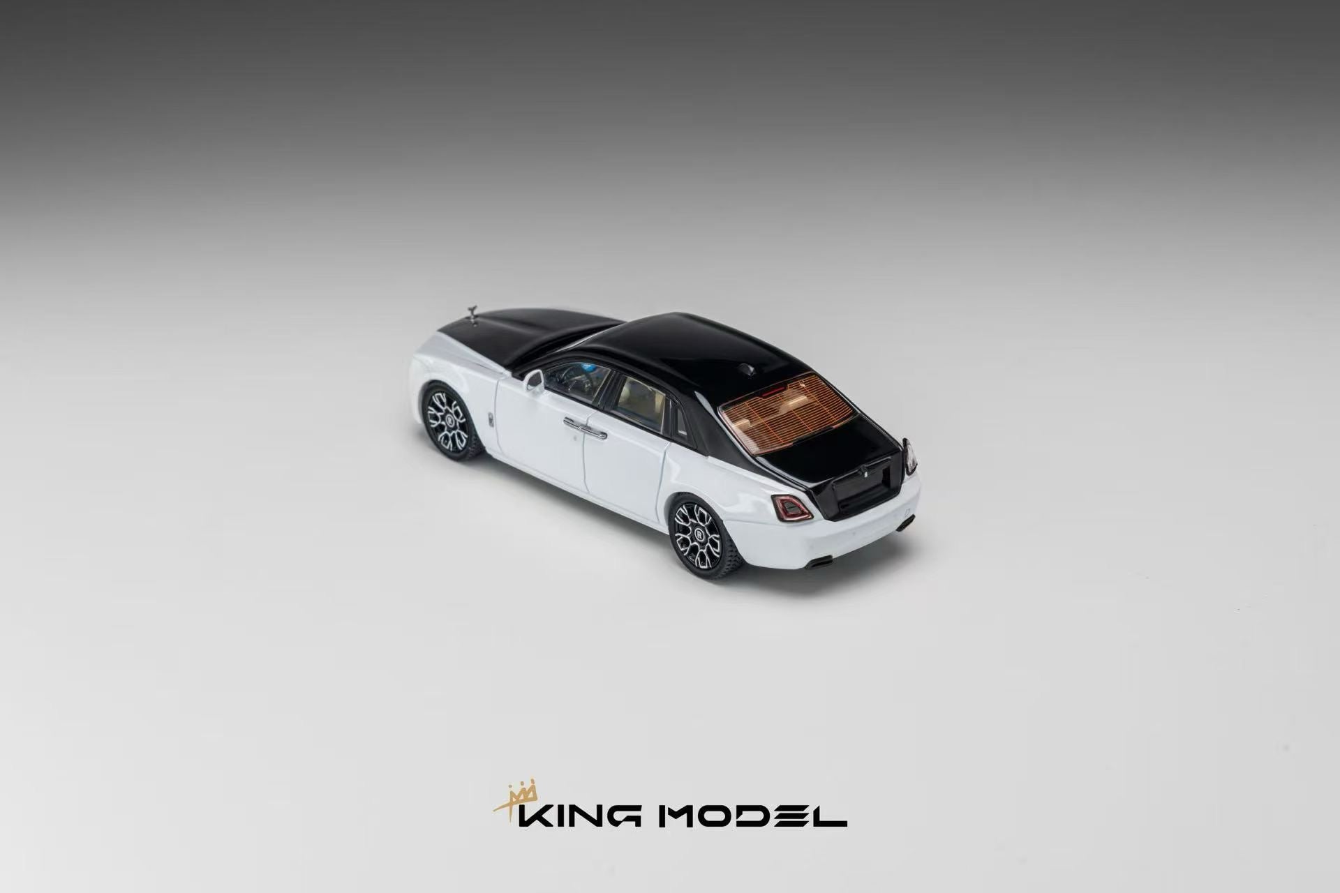 A white Rolls-Royce Phantom model car with a black roof and brown interior, shown from a three-quarters rear angle on a gray gradient background with the KING MODEL logo at the bottom.