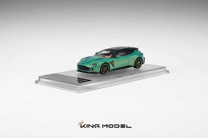 A metallic green Aston Martin Vantage diecast model car with a black roof and gold wheels, displayed on a clear acrylic stand with a King Model logo at the bottom.