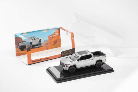 Model truck on a display stand with packaging in the background