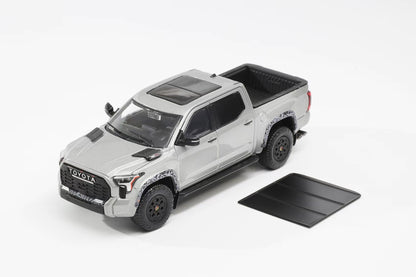 Model toy truck with open bed on a white background