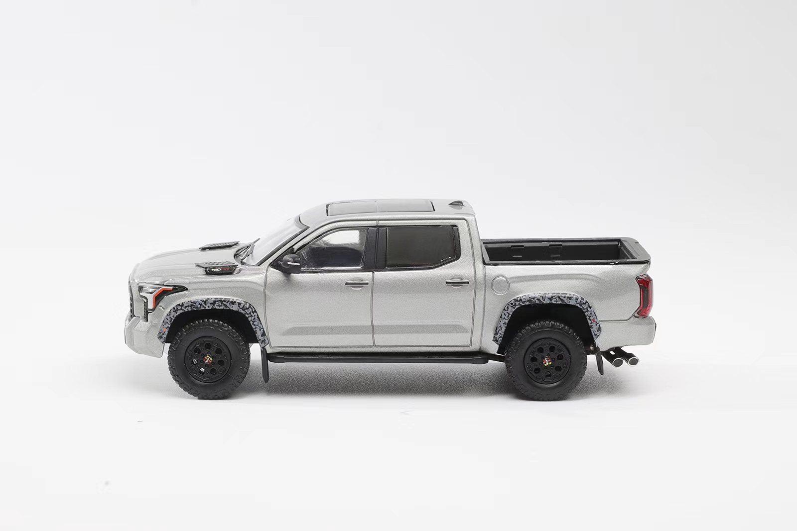 Model of a white pickup truck on a white background