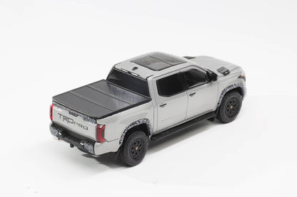 Model of a silver truck with a TONPROR cover on a white background