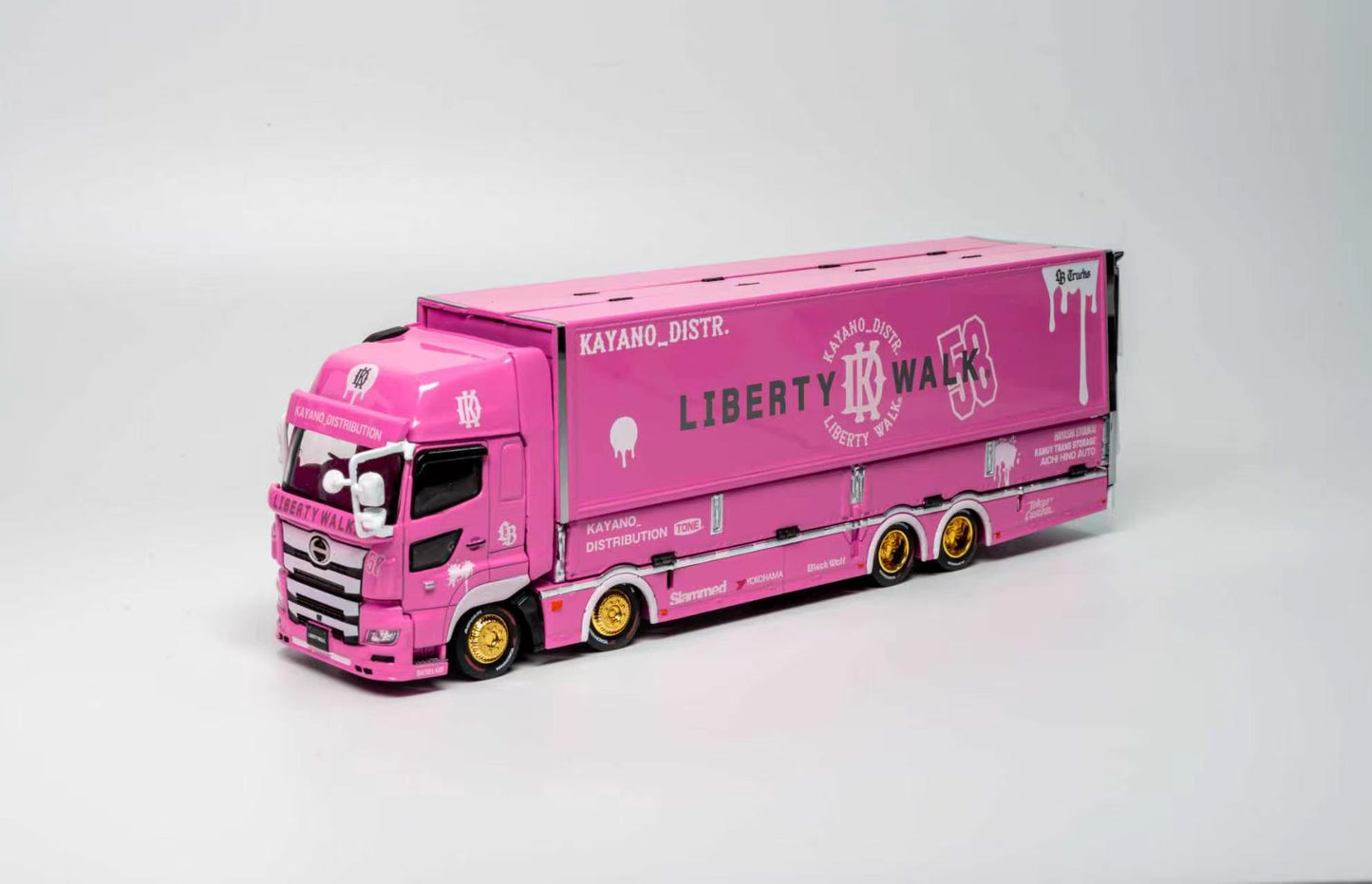 A pink toy model semi-truck with a matching pink cargo box, featuring 'LIBERTY K WALK' and 'KATAHO_DISTR.' branding, displayed on a light gray studio background.