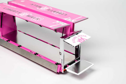 A pink and silver cardboard food truck kit with printed graphics, shown open on a light gray background.