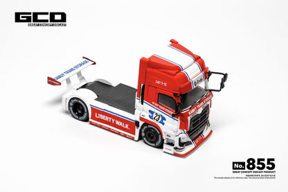 A 1:64 scale model of a red and white semi-truck with racing livery, displayed on a clean white background. The model features a detailed cab, a flatbed trailer, and various sponsor decals including 'Liberty Walk' and 'Red Bull'.