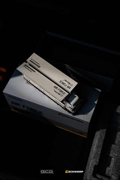 A detailed model truck labeled 'Air Force' displayed on a box, showcasing craftsmanship and design in a dark setting.