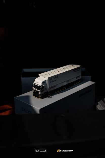 Hino Profia 700 DarwinPro &TECKWRAP Combat Grey truck on a box with 'Teckwrap' and 'GCD' branding in a dark setting