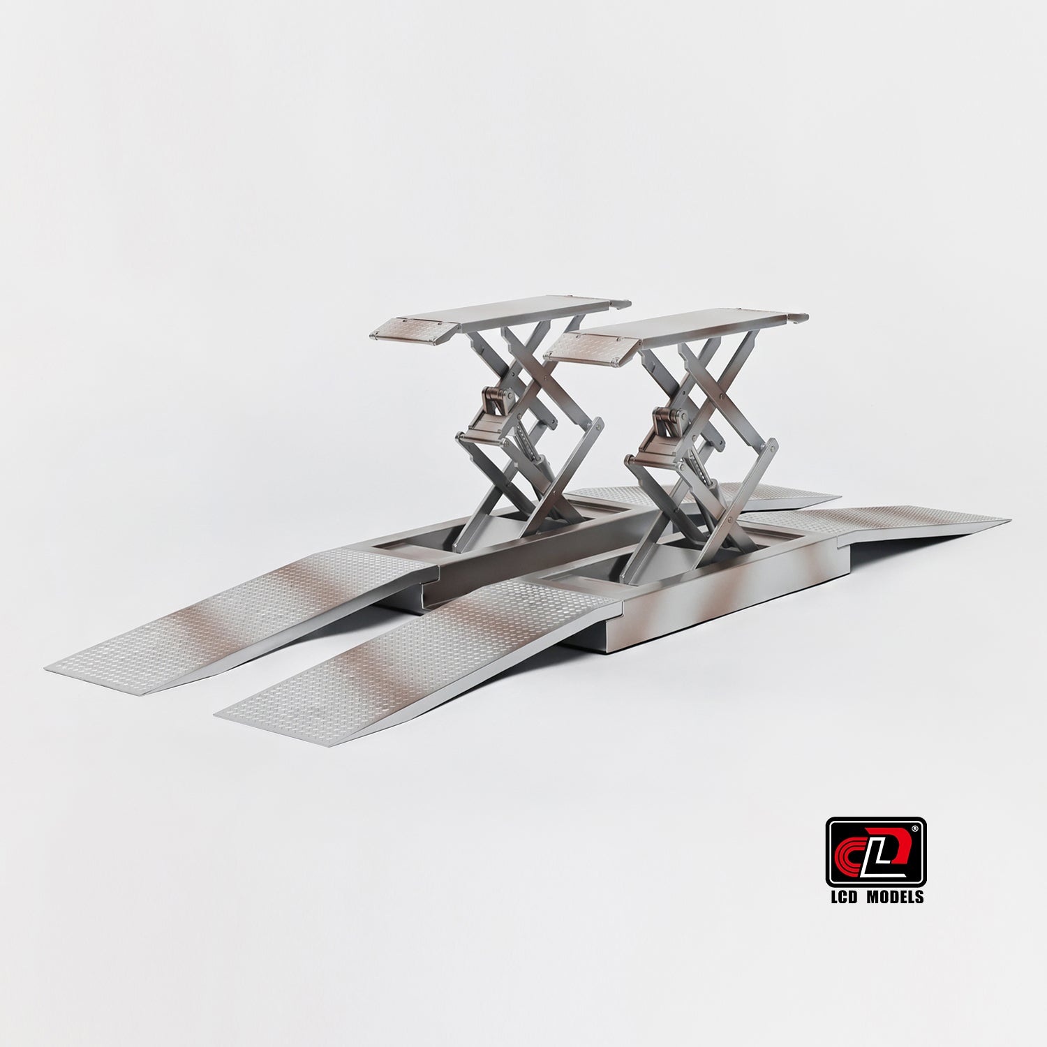 Metallic car lift on a white background with a visible brand logo.