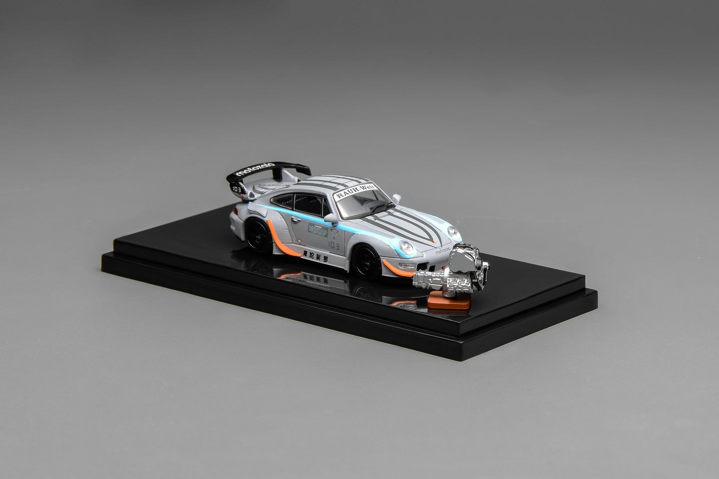 Model car on a black display stand with a gray background