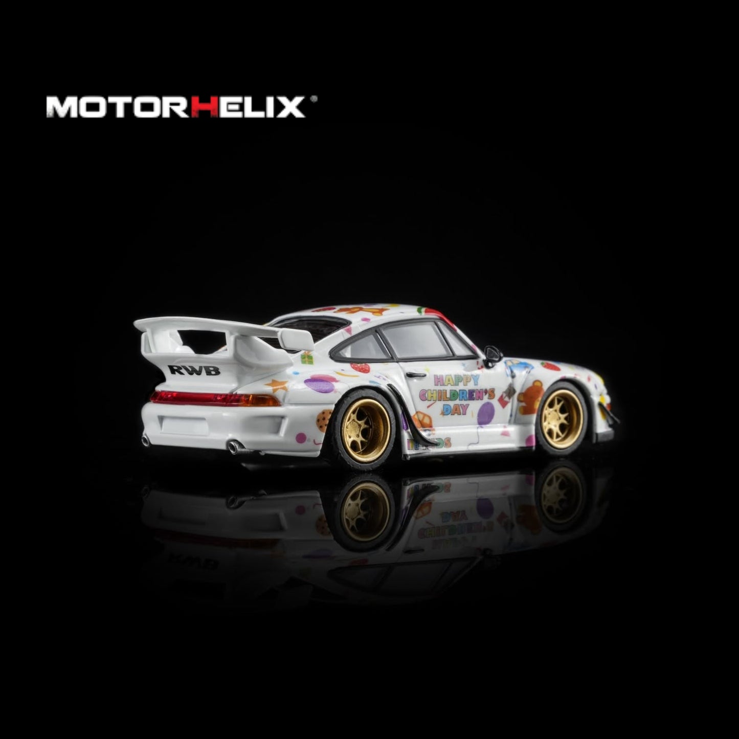 A white widebody sports car model with colorful graffiti-style decals, gold wheels, and a large rear wing, shown on a black reflective background. The MOTOR HELIX logo appears in the top left.