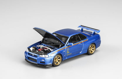 MotorHelix Nissan Skyline GT-R R34 1:64 diecast model in metallic blue, Hong Kong Toycar Salon 2026 exclusive M63453DZ-PT, opening hood with detailed engine bay, gold wheels, side graphics and rear wing.