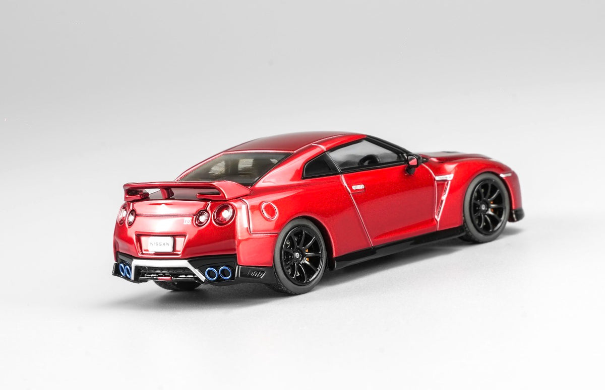 MotorHelix Nissan GT-R R35 1:64 diecast model in metallic red, Hong Kong Toycar Salon 2026 exclusive M63519DZ-PT, rear three-quarter view with rear spoiler, black wheels and quad exhaust tips.