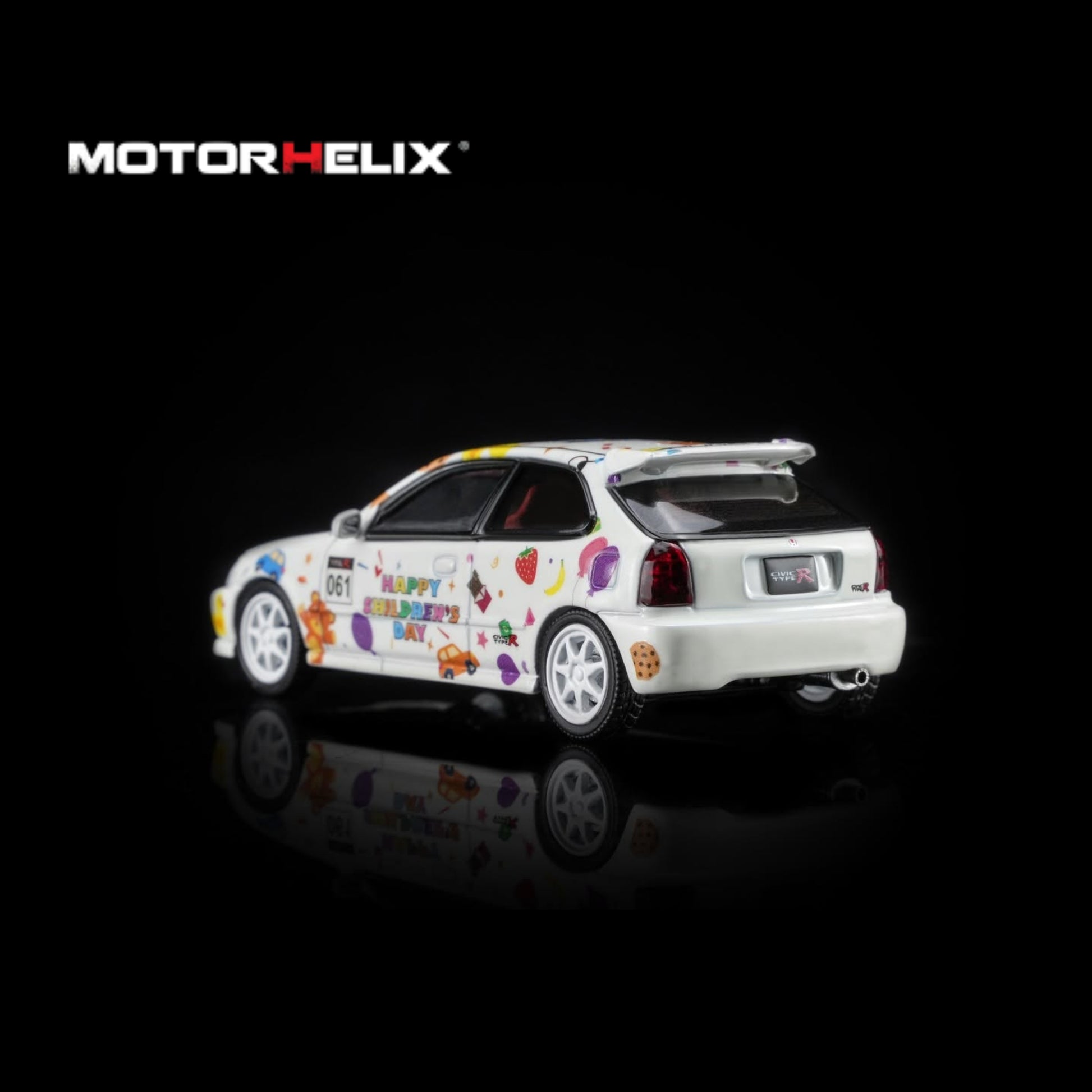 A white diecast model car with colorful retro graphics and text, shown from a three-quarter rear angle on a black reflective background with the MOTOR HELIX logo in the top left.