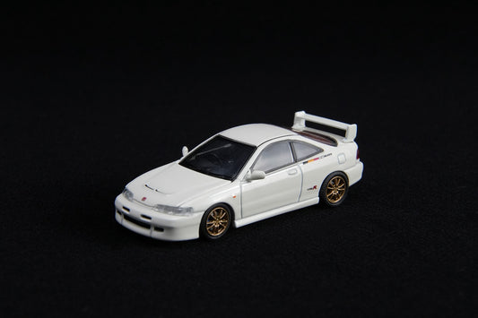 White model car with gold wheels on a black background