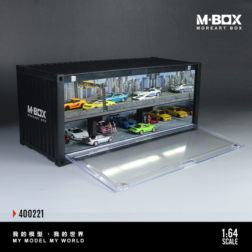Model car display case with two levels of colorful sports cars set against a city skyline backdrop. Transparent front cover, labeled "M-BOX."