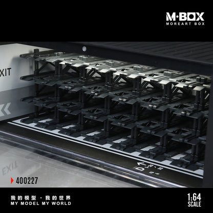 Model train track set with 'M-Box' branding on a black background