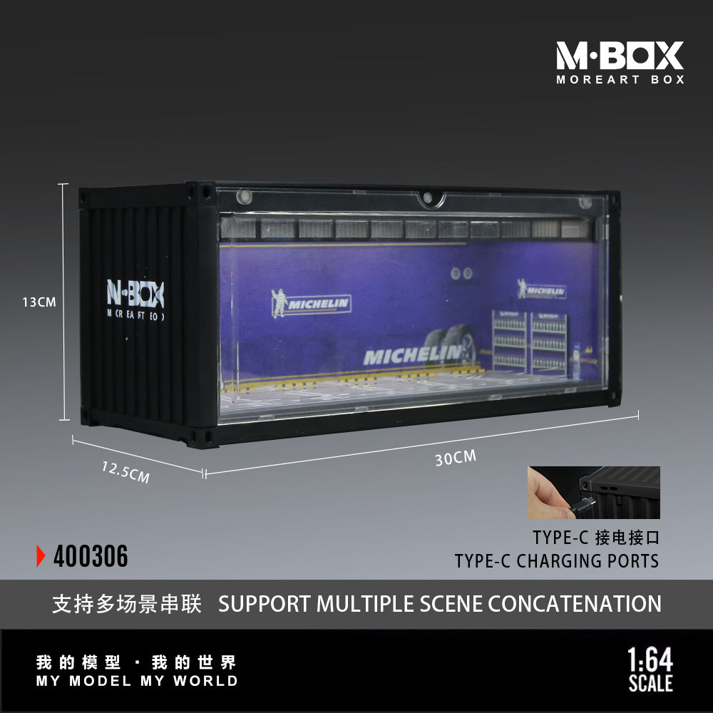 A black display box labeled "M-BOX MOREART BOX" with a "Michelin" logo inside. It measures 30cm x 12.5cm x 13cm, includes Type-C charging ports, supports scene concatenation, and is at a 1:64 scale.