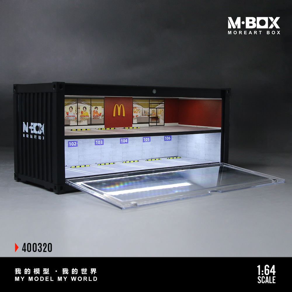 Model of a McDonald's restaurant interior in a black container with M-BOX branding.