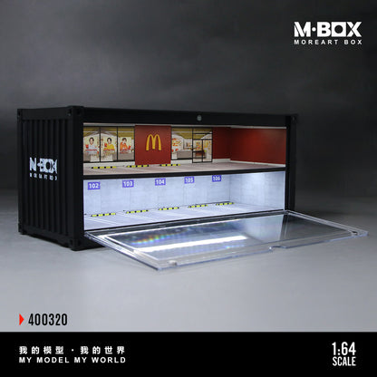 Model of a McDonald's restaurant interior in a black container with M-BOX branding.