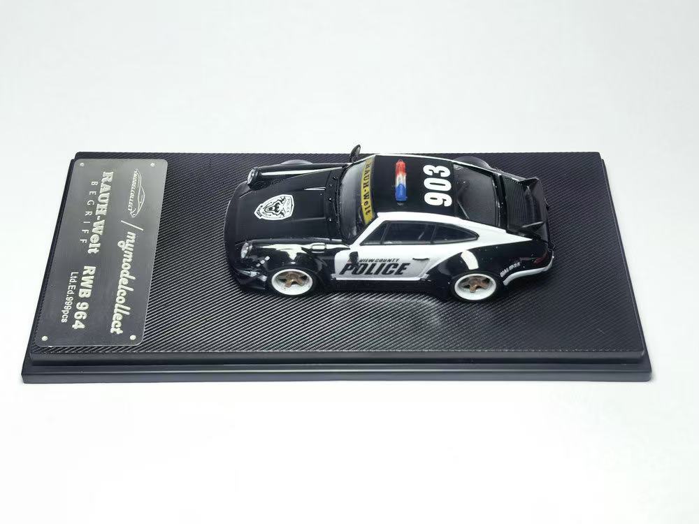 Model police car on a display stand with a white background