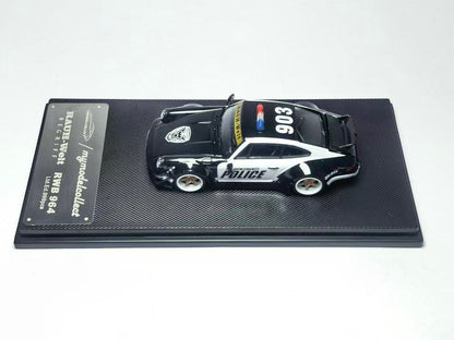 Model police car on a display stand with a white background