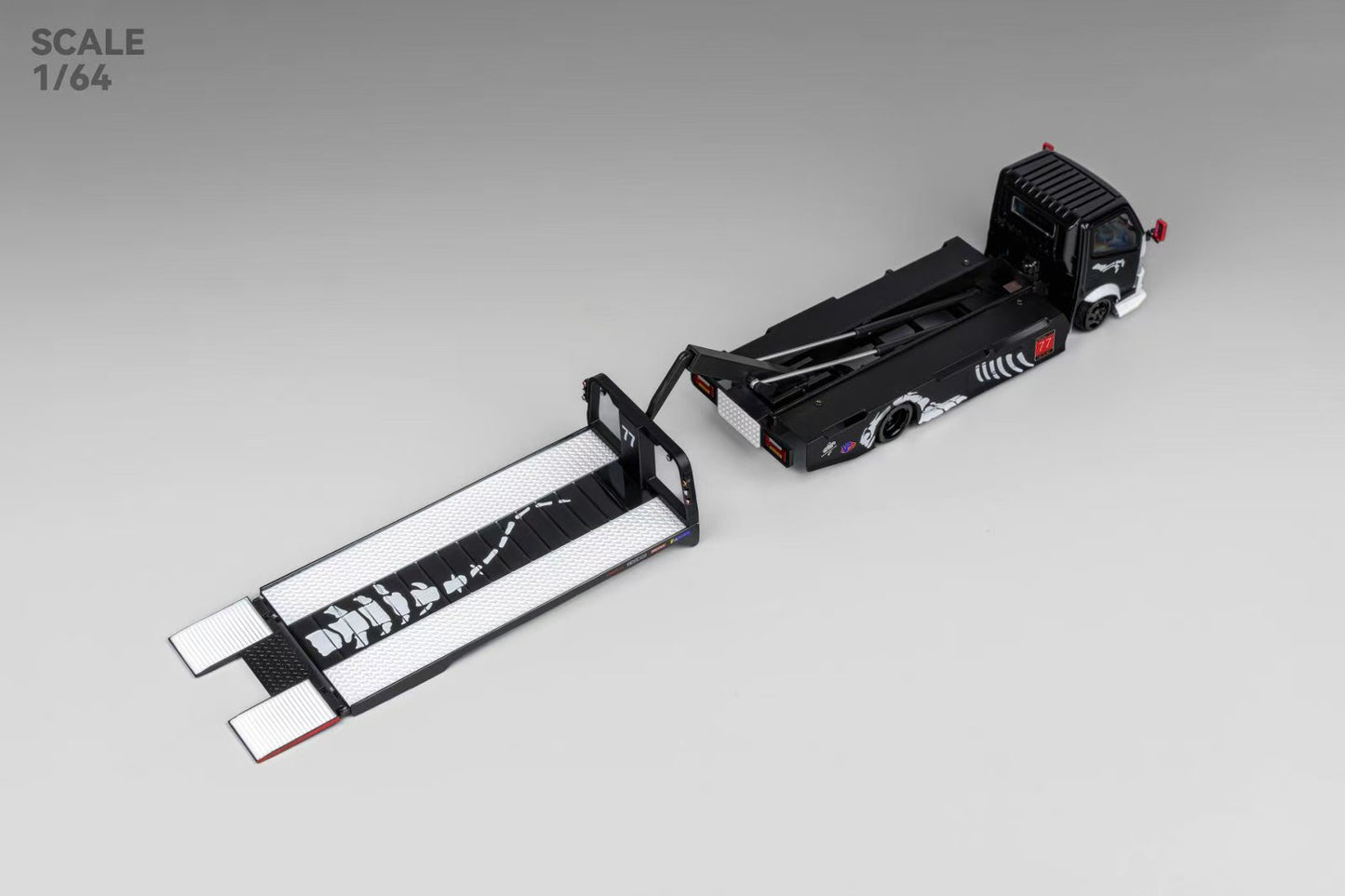 Miniature black tow truck model on a 1/64 scale. Features detailed flatbed extended with a white and black skeleton design, creating a sleek, modern look.