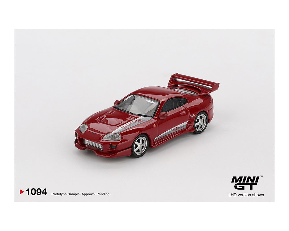 Red model car on a white background with 'MINI GT' branding.