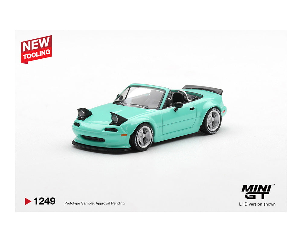 Turquoise model car on a white background with 'MINI GT' branding.